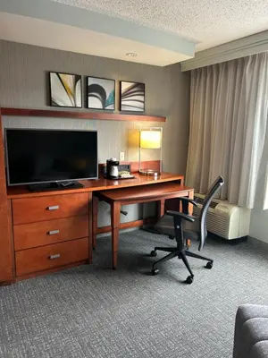 a hotel room with a desk with a television at Courtyard Bethlehem Lehigh Valley/I-78 in Bethlehem