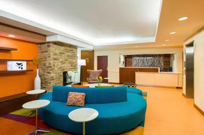 a living room with a blue couch and tables at Best Western Allentown Bethlehem Lehigh Valley Inn & Suites in Bethlehem