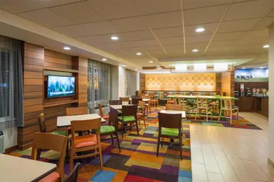 a restaurant with tables and chairs and a tv at Best Western Allentown Bethlehem Lehigh Valley Inn & Suites in Bethlehem