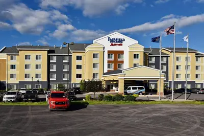 a hotel with a red truck parked in a parking lot at Fairfield by Marriott Wilkes-Barre in Wilkes-Barre
