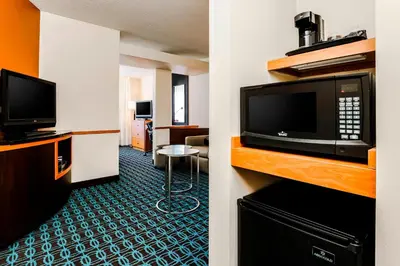 a hotel room with a microwave and a television at Fairfield by Marriott Wilkes-Barre in Wilkes-Barre