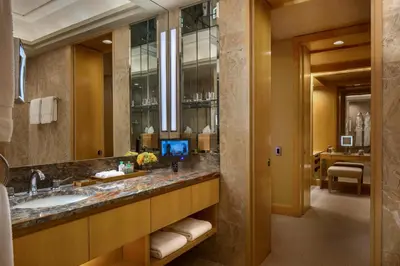a bathroom with a sink and a large mirror at Four Seasons Hotel New York in New York