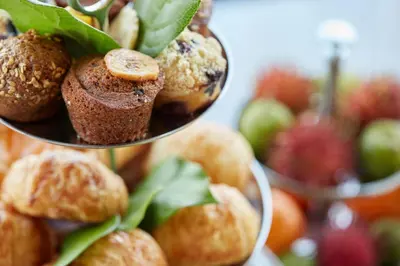 a pile of muffins and fruit on a plate at Four Seasons Hotel New York in New York