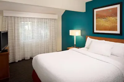a hotel room with a large bed and a television at Residence Inn Binghamton in Vestal
