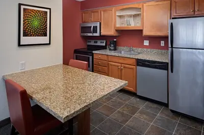 a kitchen with a refrigerator and a counter top at Residence Inn Binghamton in Vestal