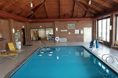 a large swimming pool in a building with a large at Fairfield Inn by Marriot Binghamton in Binghamton