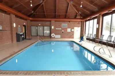 a large swimming pool in a large room with windows at Fairfield Inn by Marriot Binghamton in Binghamton