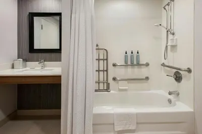 a bathroom with a bath tub and a sink at Courtyard Binghamton in Vestal
