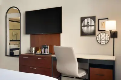 a hotel room with a desk with a white chair at DoubleTree by Hilton New York Downtown in New York