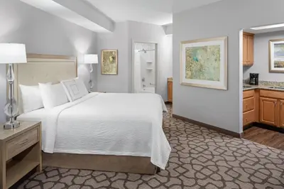 a bedroom with a large white bed and a bathroom at Residence Inn by Marriott West Orange in West Orange