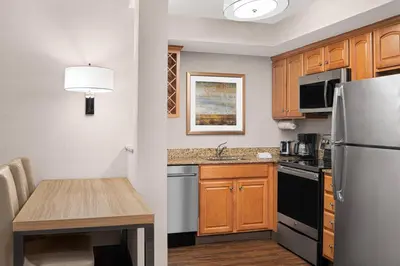 a small kitchen with a table and a refrigerator at Residence Inn by Marriott West Orange in West Orange