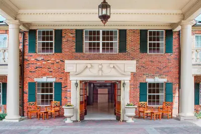 a large brick building with chairs in front of it at Residence Inn by Marriott West Orange in West Orange