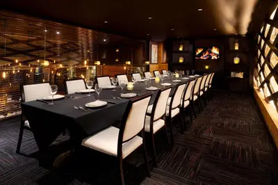 a long dining room with a long table and chairs at Courtyard Montvale in Montvale