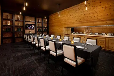 a long dining room with a long table and chairs at Courtyard Montvale in Montvale