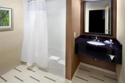 a bathroom with a sink and a toilet and a mirror at Fairfield Inn by Marriott East Rutherford Meadowlands in East Rutherford