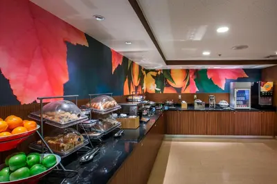 a buffet line in a restaurant with food at Fairfield Inn by Marriott East Rutherford Meadowlands in East Rutherford