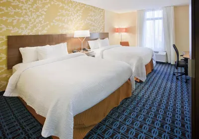 a hotel room with two beds with white sheets at Fairfield Inn by Marriott East Rutherford Meadowlands in East Rutherford