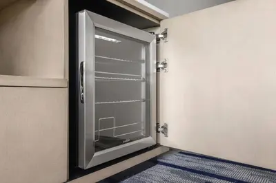an open glass door in a room with a blue rug at Marriott Saddle Brook in Saddle Brook
