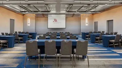 a conference room with a large table and chairs at Marriott Saddle Brook in Saddle Brook