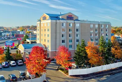 an aerial view of a hotel with cars parked in a parking lot at Fairfield Inn & Suites Woodbridge in Avenel