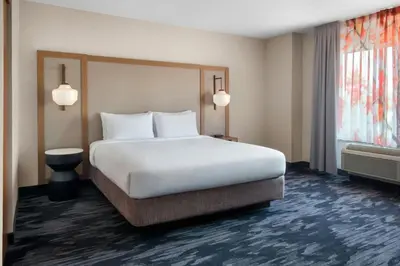 a hotel room with a large bed and a window at Fairfield Inn & Suites Woodbridge in Avenel