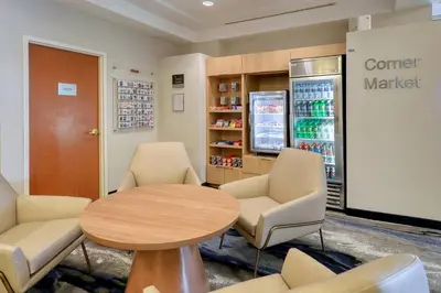 a waiting room with a coffee table and chairs at Fairfield Inn & Suites Woodbridge in Avenel