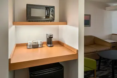 a room with a coffee maker and a microwave at Fairfield Inn & Suites Woodbridge in Avenel