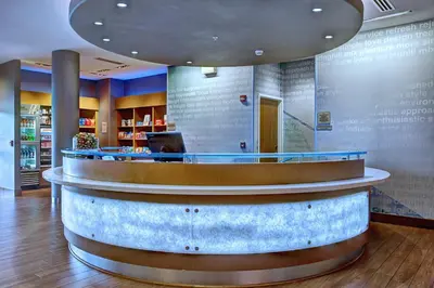 a lobby with a circular counter in a restaurant at SpringHill Suites Harrisburg Hershey in Harrisburg