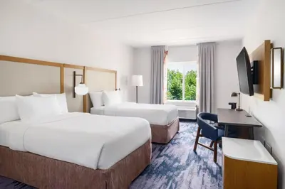 a hotel room with two beds and a desk at Fairfield Inn Harrisburg Hershey in Harrisburg