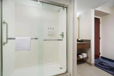 a shower with a glass door in a bathroom at Fairfield Inn Harrisburg Hershey in Harrisburg