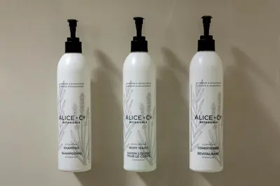 three white shampoo bottles sitting on a wall at SpringHill Suites by Marriott Hershey Near The Park in Hershey