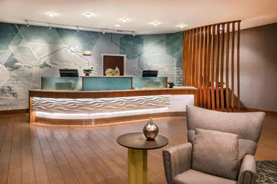 a waiting room with a chair and a waiting desk at SpringHill Suites by Marriott Hershey Near The Park in Hershey