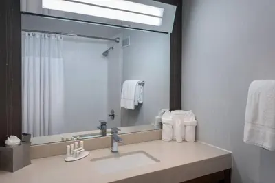 a bathroom with a sink and a large mirror at Courtyard Newburgh Stewart Airport in Newburgh