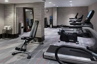 a gym with several treadmills and cardio machines at Courtyard Newburgh Stewart Airport in Newburgh