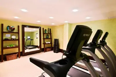 a gym with two tread machines in a room at Courtyard Newburgh Stewart Airport in Newburgh