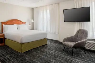 a hotel room with a bed and a chair at TownePlace Suites Wilmington Newark / Christiana in Newark