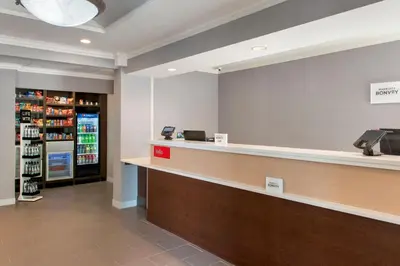 a waiting room at a pharmacy with a cash counter at TownePlace Suites Wilmington Newark / Christiana in Newark