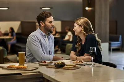 a man and a woman sitting at a table with food at Courtyard Lancaster in Lancaster