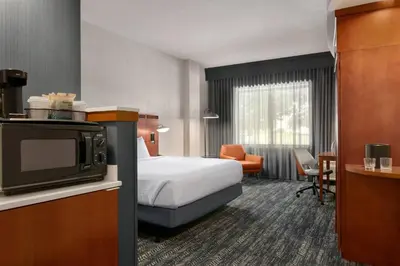 a hotel room with a bed and a tv at Courtyard Lancaster in Lancaster