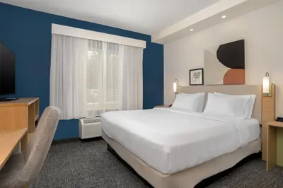 a hotel room with a bed and a television at Spark by Hilton Lancaster in Lancaster
