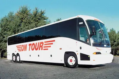 a large white bus parked in a parking lot at Spark by Hilton Lancaster in Lancaster