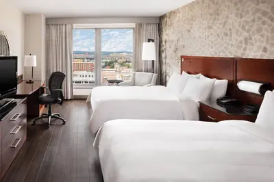 a hotel room with two beds and a television at Lancaster Marriott at Penn Square in Lancaster