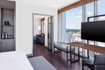 a room with a living room with a flat screen tv at Lancaster Marriott at Penn Square in Lancaster