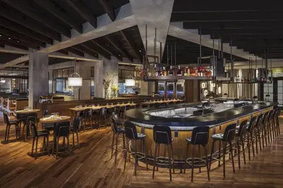 a bar in a restaurant with tables and chairs at Lancaster Marriott at Penn Square in Lancaster