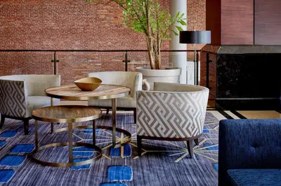 a living room with chairs and a table and a couch at Lancaster Marriott at Penn Square in Lancaster