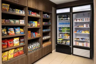 a grocery store aisle with two large refrigerators at Residence Inn Philadelphia Conshohocken in Conshohocken
