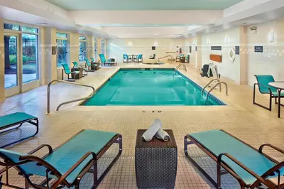 a pool in a hotel room with chairs and a pool at Residence Inn Philadelphia Conshohocken in Conshohocken