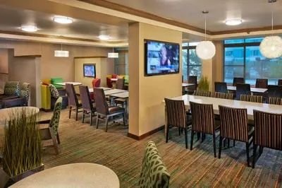 a restaurant with tables and chairs and a tv at Residence Inn Philadelphia Conshohocken in Conshohocken