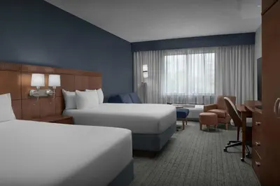 a hotel room with two beds and a desk at Courtyard Philadelphia Great Valley/Malvern in Malvern