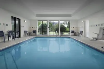 a swimming pool with blue water in a building at Courtyard Philadelphia Great Valley/Malvern in Malvern